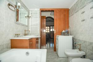 a bathroom with a tub and a sink and a toilet at Strevagio family house in Kissamos