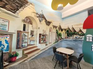 a city street mural in a room with a table and chairs at 蘑菇村-童心未泯民宿 in Taitung City