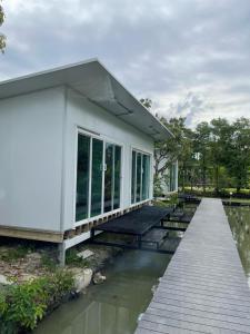 a rendering of a house with a dock at Wild Ones Hostel in Bangkok