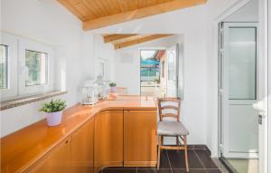 a kitchen with a wooden counter and a chair at Amazing Home In Rovinj With Kitchen in Rovinj