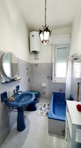 a bathroom with a blue sink and a tub at Casetta Nonna Giacomina 1camera da letto e soggiorno con angolo cottura in Valderice