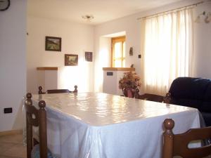 a dining room table with a white table cloth on it at Casa Iride in Canale San Bovo
