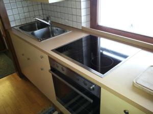 a kitchen with a sink and a stove at Ferienwohnung Lisbeth Ambra in Hermagor