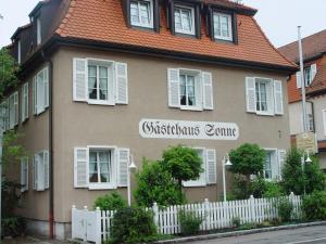 a house with a white fence in front of it at Gasthof zur Sonne in Stuttgart