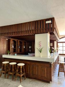 a large kitchen with a bar with stools at Theodorou Beach Hotel Apartments in Kos