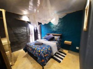 a bedroom with a bed in a blue room at Vulture's View 6 in Hartbeespoort