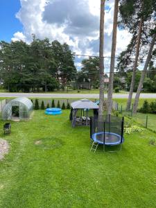 a yard with a tent and two trampols at Paralepa Guest House in Haapsalu
