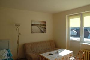 a living room with a couch and a table at Apartamenty sopot-topos in Sopot