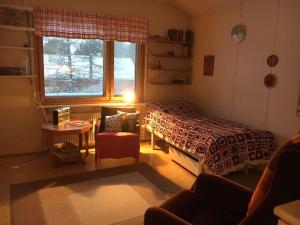 a bedroom with a bed and a window at Authentic Arctic Country House By the River in Saunavaara