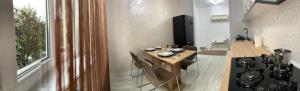 a kitchen with a table with chairs and a stove at Central Alexa Apartament in Bacău