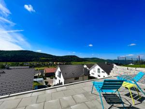 a couple of chairs sitting on a roof at Living797 in Albstadt