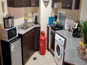 a kitchen with a fire hydrant in the middle of a kitchen at Studio in Remraam in Dubai