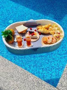 a tray of food on a table in a swimming pool at Malibu Pool Villa Pattaya in Pattaya Central
