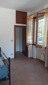 a room with a bed and two windows and a floor at Ai Boschi in Ozzano dell'Emilia