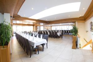 a banquet hall with tables and chairs in a room at Landgasthof Bieg in Neuler