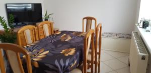 a dining room table and chairs with a flower pattern on it at Apartament I Love Gdynia in Gdynia