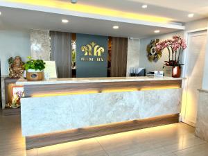 a lobby of a new era salon with a reception counter at Nam Hy 1 Hotel in Ho Chi Minh City
