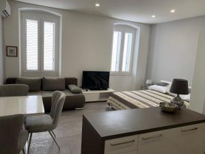 a living room with a bed and a couch at Zara City Apartments in Zadar