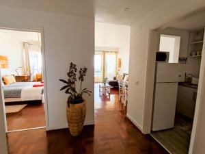 a kitchen and a living room with a refrigerator at The Lidosol - Phenomenal view over the Atlantic Ocean in Funchal