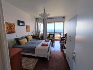 a bedroom with a bed and a view of the ocean at The Lidosol - Phenomenal view over the Atlantic Ocean in Funchal