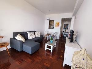 a living room with a couch and a table at The Lidosol - Phenomenal view over the Atlantic Ocean in Funchal