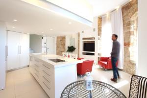 a man standing in the kitchen of a house at The White House Jerusalem סוויטת הבית הלבן ירושלים in Jerusalem +16 photos