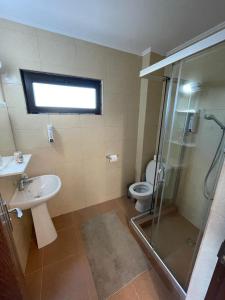 a bathroom with a shower and a sink and a toilet at Hacienda del Mar'a in Vama Veche