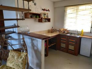 eine Küche mit einer Holztheke und einem Waschbecken in der Unterkunft Charly's place in Calibishie