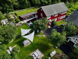 an aerial view of a red barn with a tent in the yard at Valldal Fjord Lodge B&B in Valldal