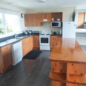 a kitchen with wooden cabinets and white appliances at The Anchorage in Niagara