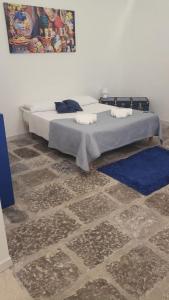 una camera con letto e tappeto blu di Baglio San Basilio a Palermo