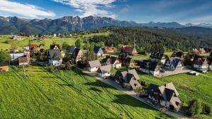 an aerial view of a small village in a green field at Apartament 1010 m in Ząb