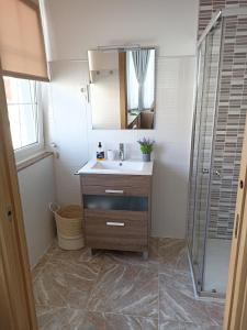 a bathroom with a sink and a shower at apartamentos Sonia YEIK in Muxia