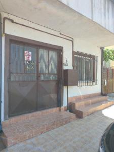 a front door of a building with steps and a window at Hostel EMY Camere cu baie proprie aproape de plaja 3 Papuci in Constanţa