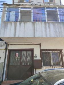 a building with a door and a car parked in front of it at Hostel EMY Camere cu baie proprie aproape de plaja 3 Papuci in Constanţa +1 photo