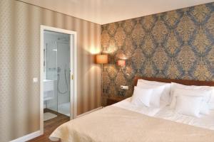 A bed or beds in a room at TI Hotel
