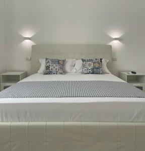 a large white bed with two pillows on it at Angela Apartment in Sorrento