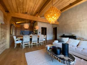 a living room with a couch and a dining room at Chalet 7 Luxury Chalet with Cinema room in Crans-Montana