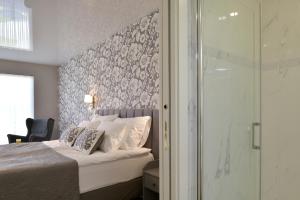 A bed or beds in a room at TI Hotel