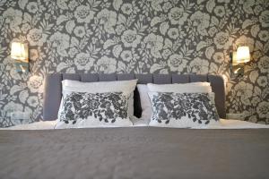 a bedroom with a bed with black and white pillows at TI Hotel in Rogaška Slatina