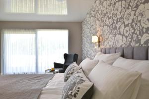 A bed or beds in a room at TI Hotel