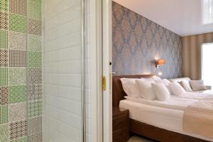 A bed or beds in a room at TI Hotel