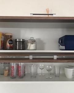 a shelf with glasses and other items on it at Chatka Maya Máchovo jezero in Doksy
