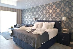 A bed or beds in a room at TI Hotel