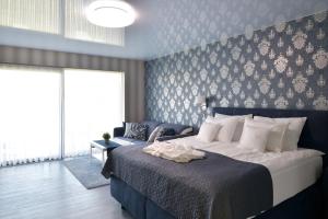 A bed or beds in a room at TI Hotel
