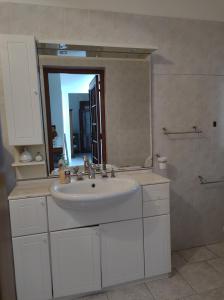 a bathroom with a white sink and a mirror at MC in Gonnesa