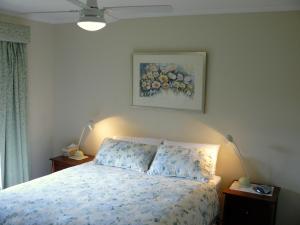 a bedroom with a bed and a painting on the wall at Camawald Coonawarra Cottage B&B in Coonawarra