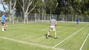 a group of people playing tennis on a tennis court at Camawald Coonawarra Cottage B&B in Coonawarra