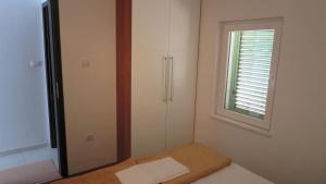 Postel nebo postele na pokoji v ubytování Apartments Orhideja