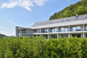 a white building with a mountain in the background at Villa Tatjana Quiet Boutique Guest House in Rogaška Slatina +70 photos